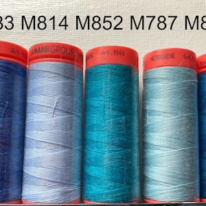 May include: Five spools of thread in different shades of blue. The spools are labeled with the numbers M683, M814, M852, M787, and M883.