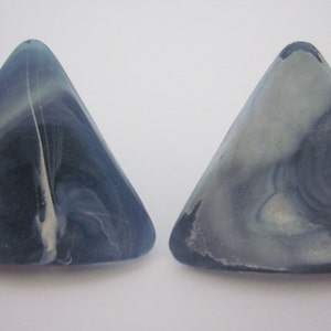 May include: Two triangular shaped, blue and white marbled, decorative pieces.