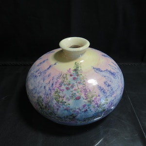 May include: A round ceramic vase with a light yellow, pink, and blue watercolour design. The vase has a wide mouth and a narrow neck.