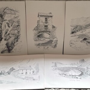 May include: Set of five black and white pencil drawings of various landscapes and buildings in the Lake District, England. The drawings depict a waterfall, a stone bridge, a cottage, and a mountain range.
