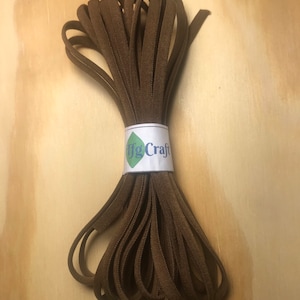 May include: A brown elastic cord, wound into a coil, with a white label that says "IfgCraft".
