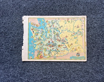 May include: A vintage map of Washington State, featuring colourful illustrations of landmarks and figures. The map has a light blue ocean, yellow land, and various cartoon-like drawings. The map is on white paper with torn edges.