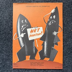 May include: Vintage propaganda poster with two anthropomorphic black missiles on an orange background. One missile holds a sign that reads "HET PAKETAM!" in red. The poster's text is in Russian, with a message about peace and the removal of missiles.