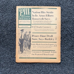 May include: A black and white newspaper front page with the headline "Nation Hits Stride In Its Arms Efforts Roosevelt Says". The newspaper is titled "PM's Weekly" and is dated August 11, 1943.