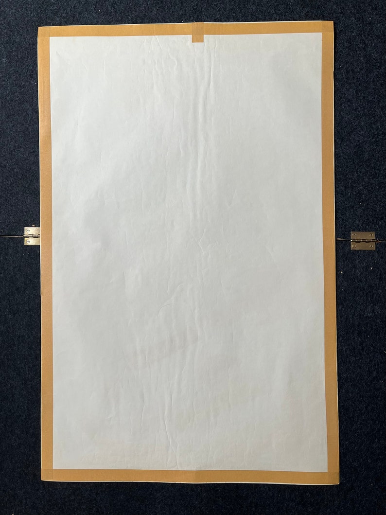 May include: A blank white poster with a brown paper border. The poster is slightly wrinkled.