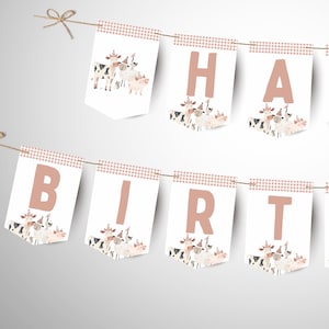 May include: A banner with the words "HAPPY BIRTHDAY" in light brown letters. Each pennant has a cow illustration and a pink and white checkered border. The banner is strung on a natural twine.