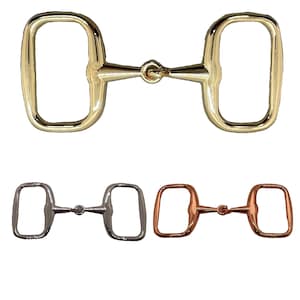 May include: Three different colored horse bit snaffles. The first is gold, the second is silver, and the third is copper.