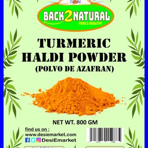 May include: A yellow turmeric powder in a pile, labeled "Turmeric Haldi Powder (Polvo de Azafran)" with a net weight of 800 grams. The label also includes the brand name "Back2Natural Pure & Healthy" and the website "www.desiemarket.com".
