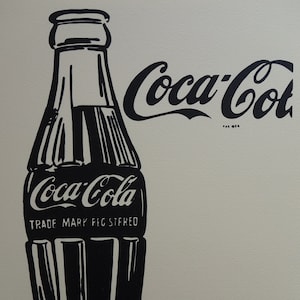 May include: Black and white illustration of a Coca-Cola bottle with the Coca-Cola logo and the text "TRADE MARK REG. STFD."
