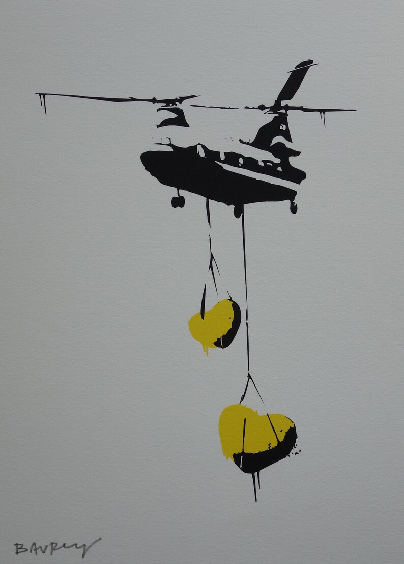 May include: A black silhouette of a helicopter carrying two yellow sacks hanging from ropes. The helicopter is against a light gray background.