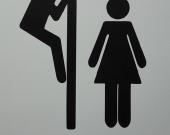 Puede incluir: Silueta en blanco y negro de una persona mirando a través de un poste y una persona de pie con los brazos a los lados. El texto "TOILET" está impreso debajo de las figuras.