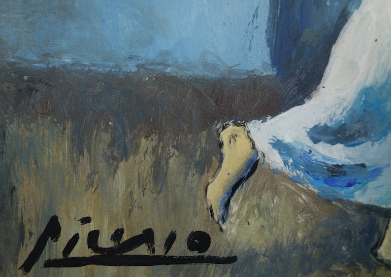 May include: A close-up of a painting with a blue and white figure in the background. The signature "Picasso" is visible in black paint in the lower right corner.