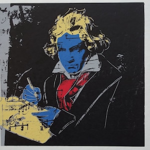 May include: A black and white print of a man with blue skin composing music. The print is signed "Andy Warhol" and numbered 19/300.
