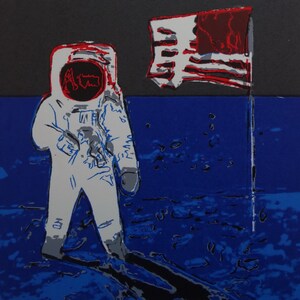 May include: A white astronaut stands on a blue and black surface with a red, white, and blue American flag planted in the ground behind him.
