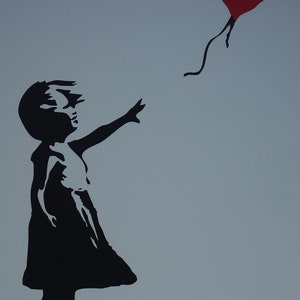 May include: A black silhouette of a girl reaching out to a red heart-shaped balloon that is floating away. The background is a light blue color. The image is signed "Banksy".
