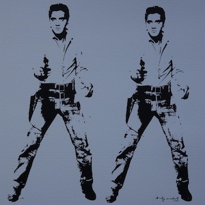 May include: Black and white print of two figures in a silhouette style, each holding a gun. The figures are wearing a shirt and jeans. The print is signed "Andy Warhol" in the bottom right corner.