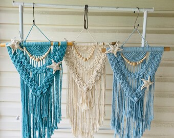 Macrame wall hanging with beads and starfish detail.