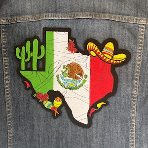 May include: Embroidered patch in the shape of Texas, featuring the Mexican flag design. The patch includes a cactus, roses, maracas, and a sombrero. The patch is attached to a denim jacket.