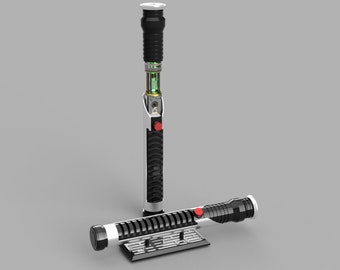 May include: A black and white lightsaber with a red button and a green light inside. The lightsaber is disassembled and the parts are lying on a gray surface.