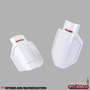 Puede incluir: Dos piezas de plástico blanco con una franja roja en la parte superior. Las piezas tienen forma de escudo y tienen un borde curvo.