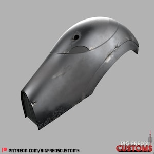 May include: A weathered, silver-coloured helmet with a visor and a small hole on the top. The helmet has a textured surface and appears to be made of metal.