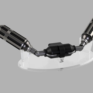 May include: A silver and black metal object with a cylindrical shape and a clear plastic stand. The object has a series of black bands around it and is connected to another cylindrical object by a silver metal joint.