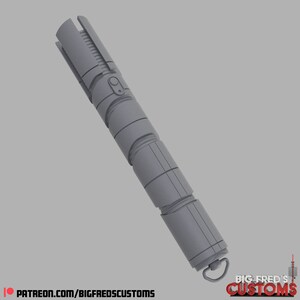 May include: A gray lightsaber with a textured surface and a black button. The lightsaber has a ring at the end with the text "BIG FRED'S CUSTOMS" on it.