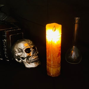 Real wax battery operated LED Hocus Pocus black flame candle.  Long lasting without the safety risks of a real flame.