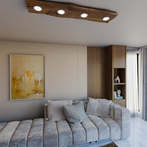 May include: A modern living room featuring a grey sectional sofa, a wooden coffee table, and a distinctive wooden ceiling light fixture with four round light bulbs.