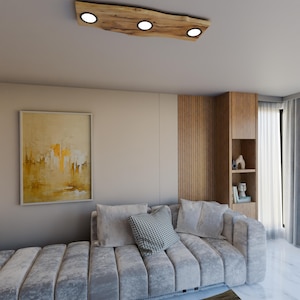 May include: A modern living room featuring a grey sectional sofa and a wooden ceiling light fixture with four round lights. The light fixture is crafted from natural wood with a rustic finish.