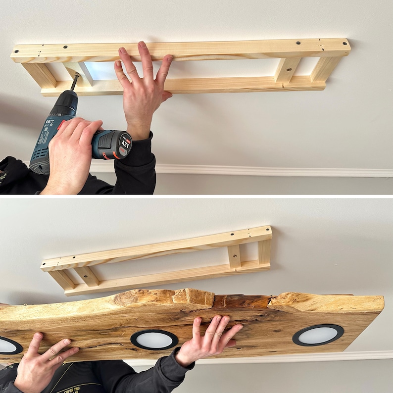 May include: A wooden frame is being attached to the ceiling with a drill. The frame will be used to support a wooden shelf with integrated lights. The shelf is made of a natural wood with a live edge and has three round lights.