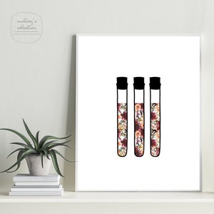 May include: Three black test tubes filled with a floral pattern in shades of pink, orange, and white.