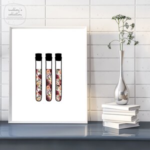 May include: Three black and white test tubes filled with a floral pattern in shades of pink, red, and orange.