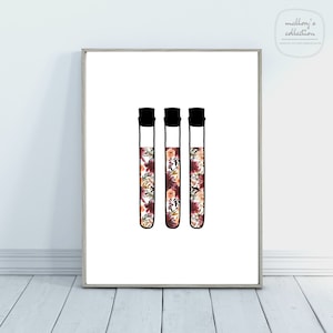 May include: Three black test tubes filled with a floral pattern in shades of burgundy, orange, and white.