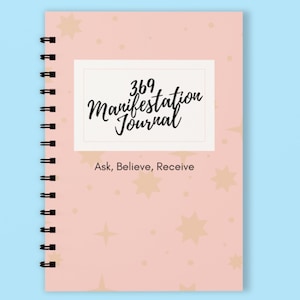 May include: A pink spiral bound journal with a white rectangle on the front that says "369 Manifestation Journal" and "Ask, Believe, Receive". The background is a pink and white pattern with gold stars.