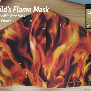 May include: A reversible child's face mask with a flame pattern. The mask has a pocket and is made by Chestnut Pony Designs.