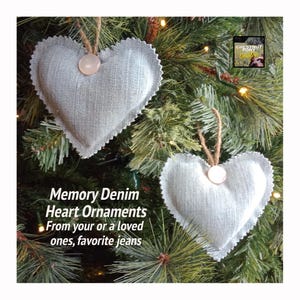 May include: Two gray denim heart ornaments hanging on a Christmas tree. The ornaments are made from repurposed denim and have a button in the center. The text "Memory Denim Heart Ornaments" is written below the ornaments. The text "From your or a loved ones, favorite jeans" is written below the first line of text.