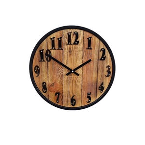 May include: A round wooden clock with black Roman numeral hour markers and black hands. The clock face is made of wood planks with a rustic finish. The clock has a black metal frame.