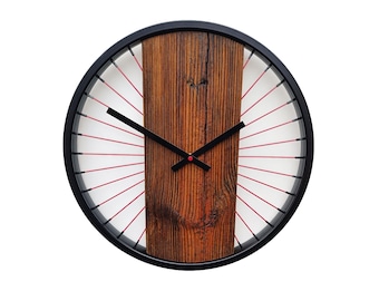 A rustic wall clock made of old wood combined with spokes and a bicycle wheel, a unique gift