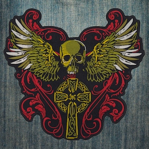May include: A black and gold embroidered patch with a skull with wings and a Celtic cross. The skull is green and the wings are green and white. The cross is gold and has a Celtic knot design.
