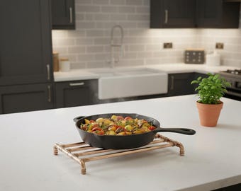 Large copper pan trivet with protective feet,