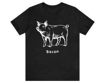 Könnte beinhalten: Schwarzes T-Shirt mit einer weißen Illustration eines Schweins. Das Wort "Bacon" ist weiß darunter gedruckt. Das T-Shirt hat kurze Ärmel und einen Rundhalsausschnitt.