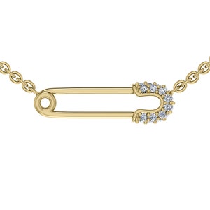 May include: A gold chain necklace with a safety pin pendant accented with small clear diamonds.