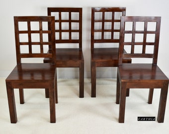 May include: Four dark brown wooden chairs with a grid pattern on the backrests. The chairs have a simple, rectangular design and are arranged in a row.