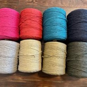 May include: Eight spools of cotton rope in various colours, including pink, red, teal, navy, grey, beige, tan, and green.