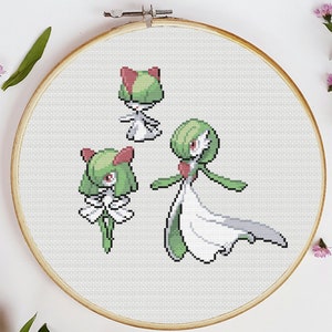 May include: Cross stitch pattern featuring three different stages of the Pokemon, Gardevoir. The pattern shows Gardevoir in its first, second, and final evolution stages. The pattern is in a white hoop.