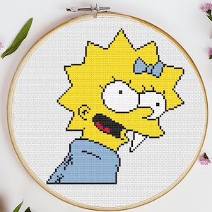 May include: Cross-stitch pattern of a yellow cartoon character with blue eyes, a blue bow, and a blue shirt. The character is smiling with a wide open mouth and has a few teeth showing.