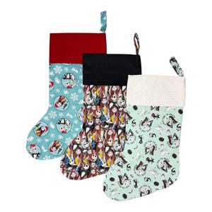 May include: Three Christmas stockings with different patterns and colors. One has a red top and a light blue body with Jack Skellington and snowflakes. Another has a black top and a patterned body. The third has a white top and a mint green body with Jack Skellington and the text "Love You to Death."