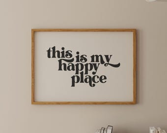 May include: A framed print with the text "This is my happy place" in a retro font style. The frame is made of natural wood and has a light brown finish.