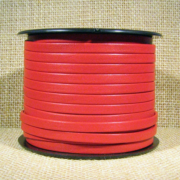 May include: A spool of red leather cord, wound around a black plastic spool. The cord is smooth and has a slight sheen.
